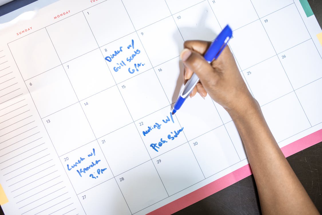 Student planning college admissions timeline on a calendar with important deadlines marked