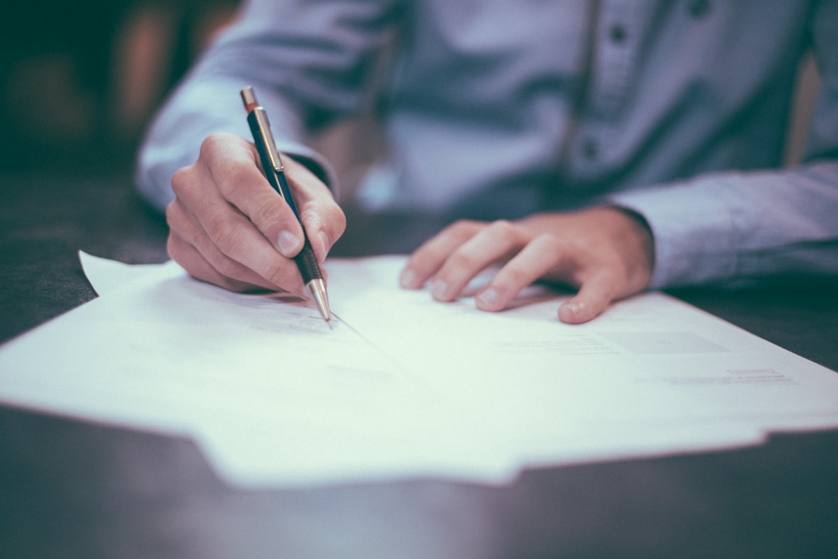 Signing an Early Decision agreement document for college admissions
