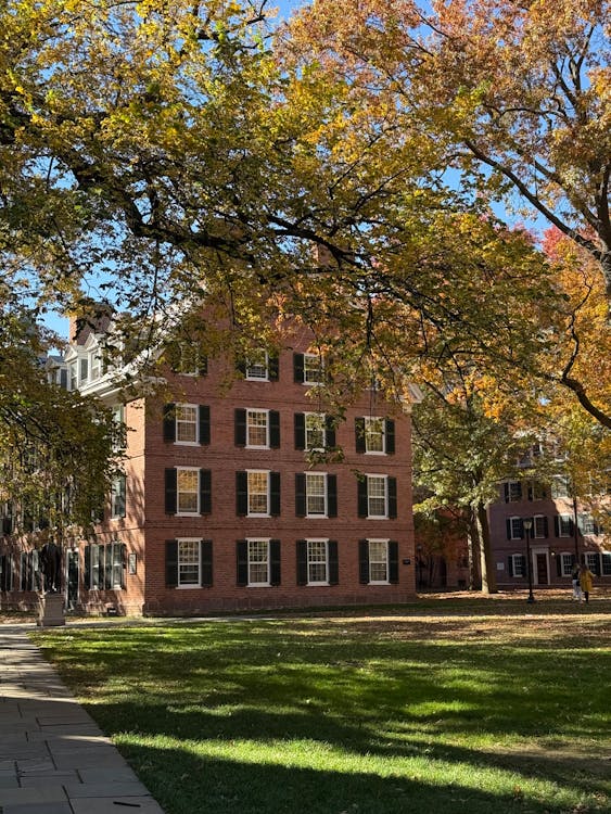 University campus building with autumn foliage representing University of Michigan