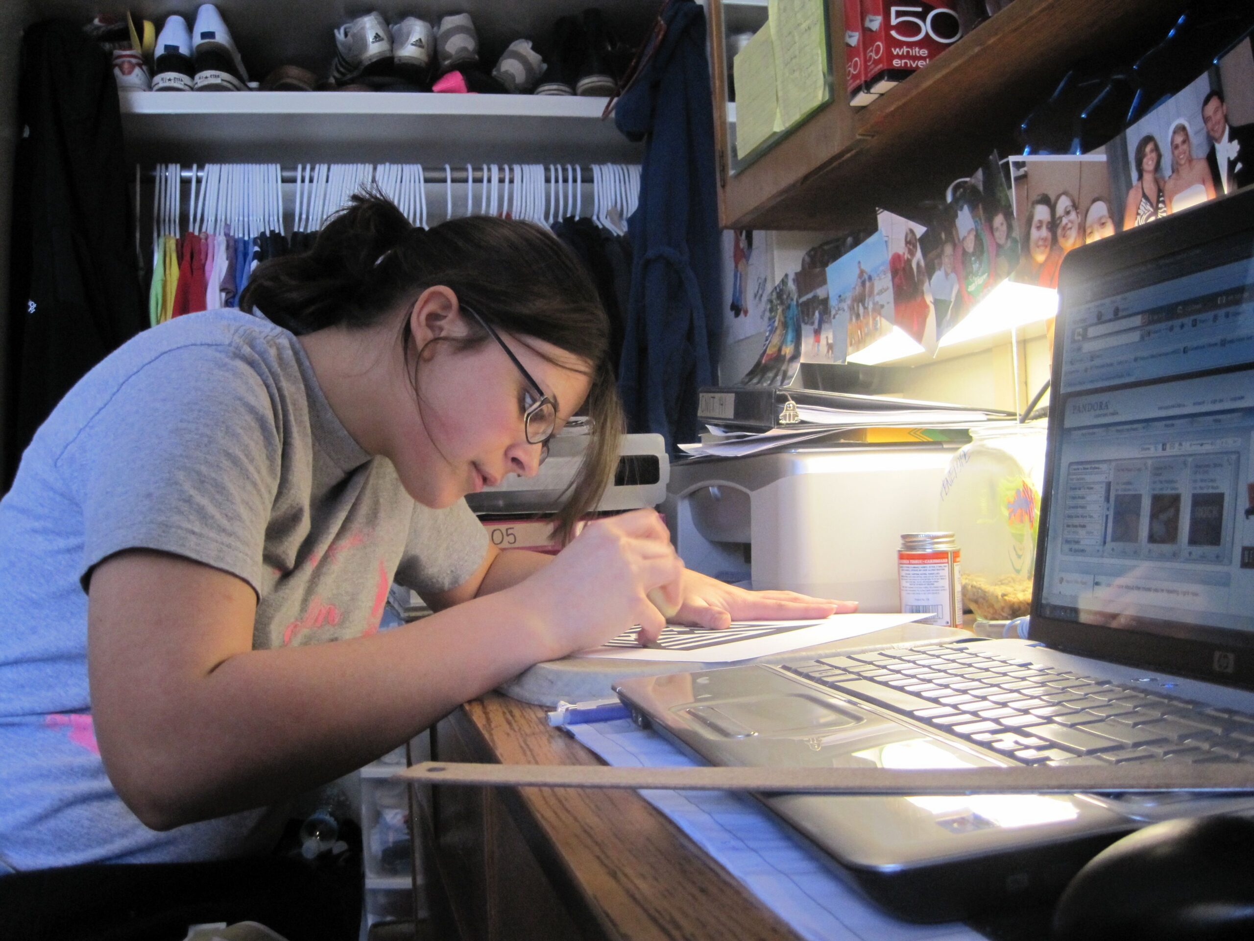 Student writing and studying independently at a desk - representing homeschool elite admissions strategy